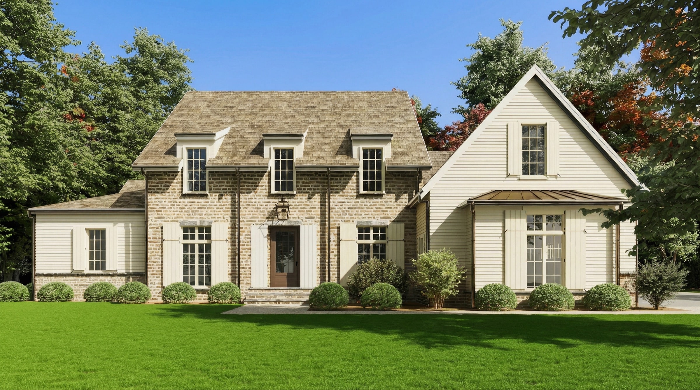 Front elevation of Stone Hollow Cottage — stone and cream clapboard with dormer windows and a shake roof