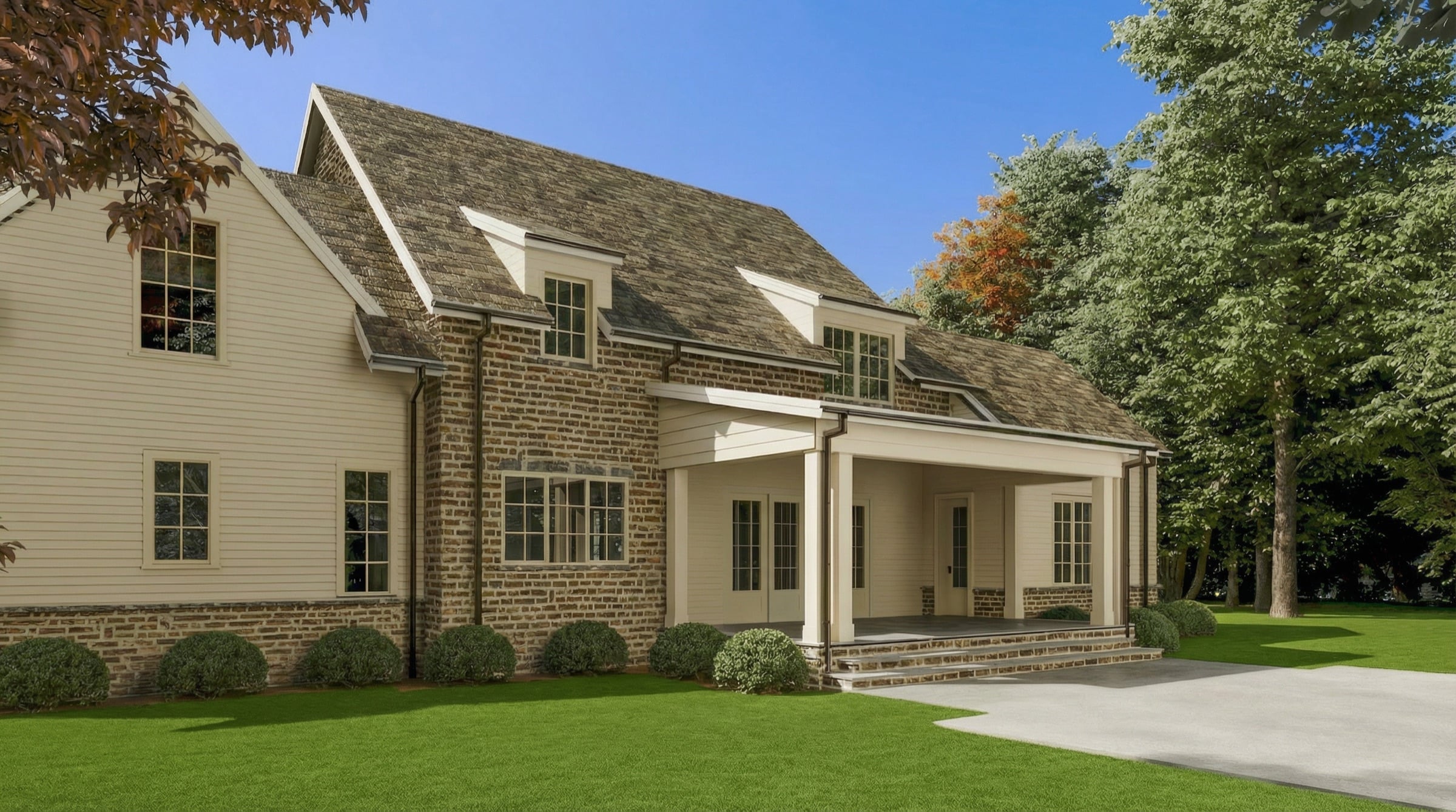 Rear elevation and covered porch of a Wilson Farm home opening onto an open lawn and mature trees